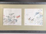 two framed asian paintings of birds and flowers on a wall