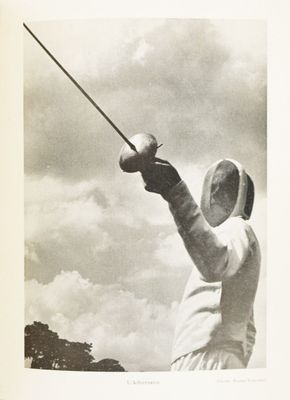 a black and white photo of a man holding a sword