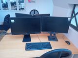 two computer monitors and a keyboard on a desk