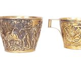 two cups that are sitting next to each other