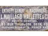 an old blue and white sign on the side of a building