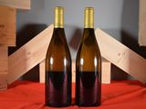 two bottles of wine sitting next to each other on a table