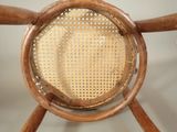 the back of a wooden chair with a woven seat and backrest
