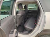 the interior of a car with the door open and the passenger seat down