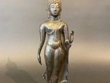 an image of a bronze statue of a woman holding a flower