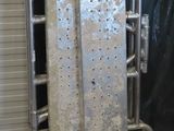 a metal rack with a bunch of pieces of metal on it