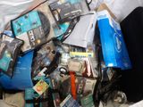a pile of electronics and other items in a trash can