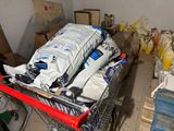 a shopping cart filled with bags of supplies in a room