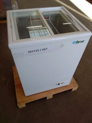 a white freezer sitting on a pallet in a warehouse