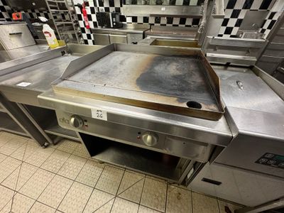 stainless steel counter top in a commercial kitchen with checkered walls