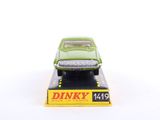 green toy car sitting on top of a box on a white surface