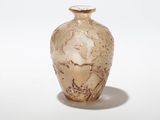 a small vase that is sitting on a white surface