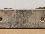 a sculpture of a bird sitting on top of a block of wood