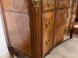 a large wooden dresser with a marble top on display