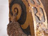 a close up of a clock on a wooden pole
