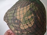 a person holding a helmet with a net on it