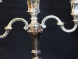 two silver candles that are sitting on a table
