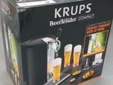 packaging of a beer dispenser with a beer glass on top of it