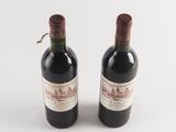 two bottles of wine sitting next to each other on a table