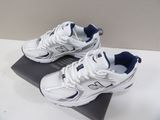 white new balance shoes with blue accents on top of a box
