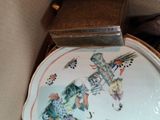 a plate with a picture on it sitting in a box