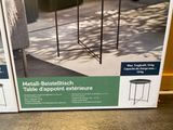 two boxes of metal plant stands on the floor