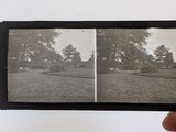 a hand holding a black and white photo of a park