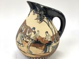 a vase with a painting on it on a white surface