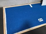 a blue area rug with a white letter on it