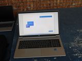 a laptop and a laptop computer sitting on a table