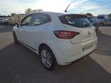 the rear end of a white car parked in a parking lot