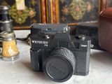 a camera and a wallet sitting on a table