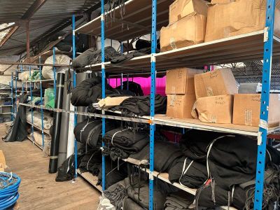 many boxes and bags on the shelves in the warehouse