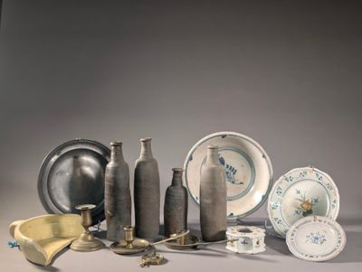 many different types of vases and plates on the table