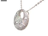 silver plated necklace with a large oval pendant with a swirl design on a chain