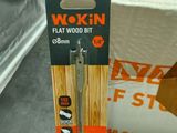 a box of wood sticks and a pair of scissors on a table