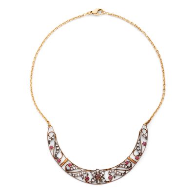 un collier en or orné d'un motif rose et blanc