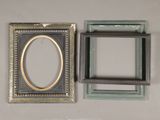 two picture frames hanging on the wall next to each other