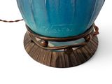 a blue vase that is sitting on a stand