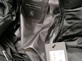 a close up of a black jacket with a tag on it