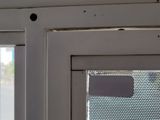 a close up of a window with holes in it