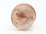 a close up of a bottle of wine on a white surface