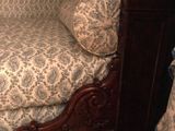 a bed with a wooden frame and a floral print cover