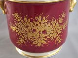an image of a red and gold bowl on a white table