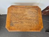 a small wooden table on the floor in a room