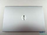 the back of a laptop computer sitting on top of a white table