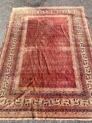 an old rug is laying on the ground on the ground