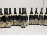 six bottles of wine are lined up in a row on a table