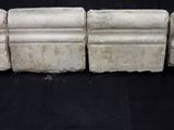 four pieces of white marble sitting on a black surface
