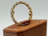 an image of a gold ring sitting on top of a wooden box
